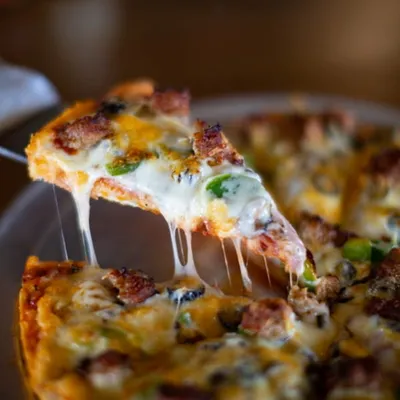 Specialty pizza with cheese pull at Spiro's Pizza & Pasta in Shoreline WA